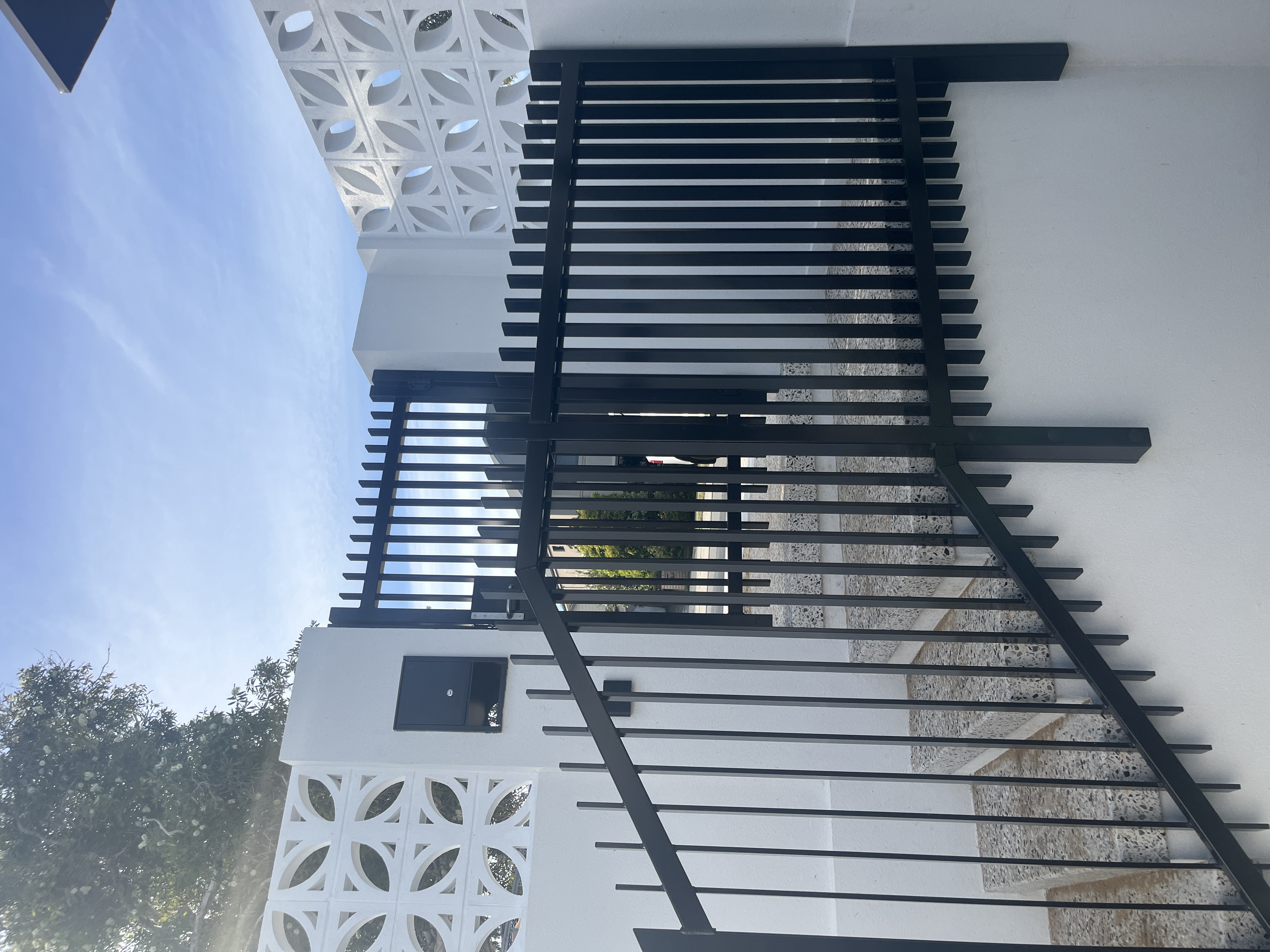 Black steel pedestrian gate and balustrade